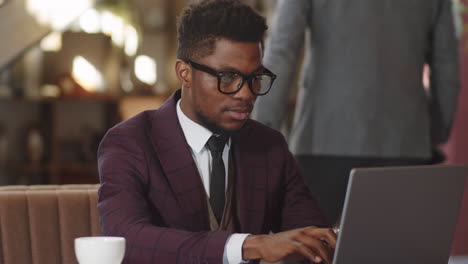 African-American-Businessman-Working-on-Laptop-in-Cafe